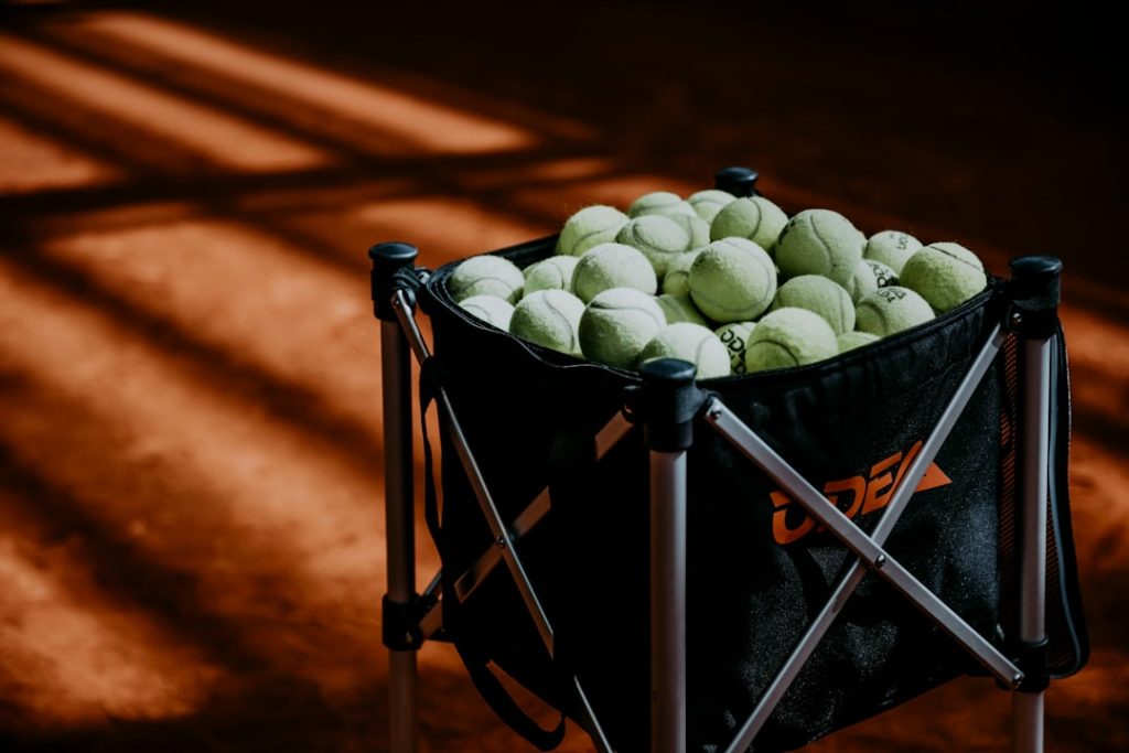 a-black-bag-filled-with-tennis-balls-on-top-of-a-tennis-court-7eqamp0pnxy a-black-bag-filled-with-tennis-balls-on-top-of-a-tennis-court-7eqamp0pnxy