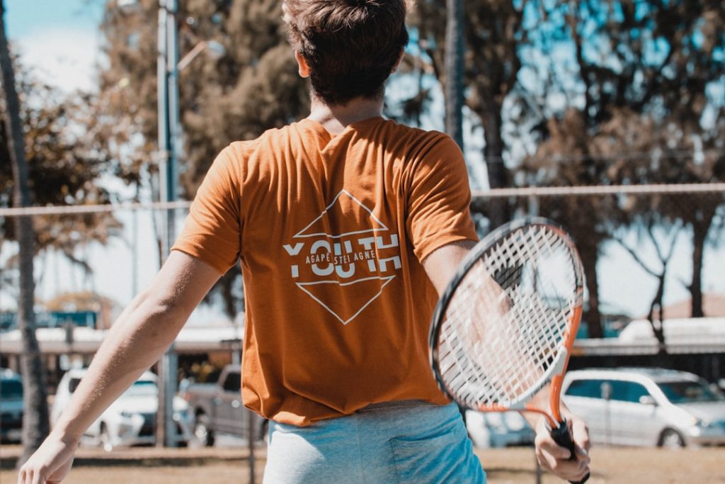 man-in-brown-crew-neck-t-shirt-and-blue-denim-jeans-holding-blue-and-white-electric-p3gfvkhz8d0 Stretching for Tennis match