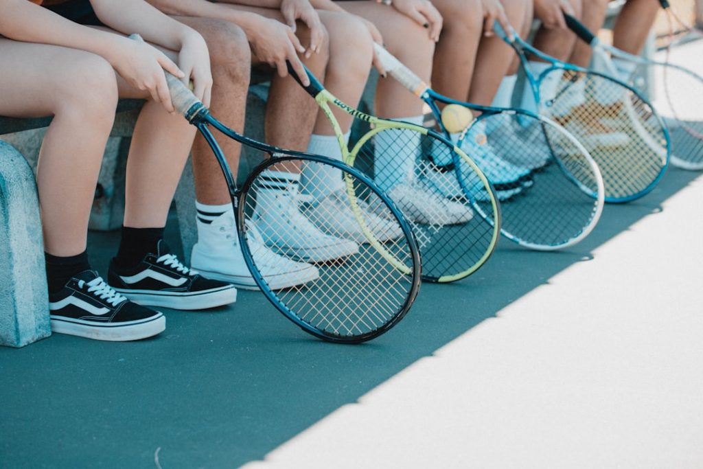 person-in-black-and-white-nike-sneakers-holding-blue-and-white-tennis-racket-rnik93wcz-u Sitting on the bench before tennis practice, want more photos like this contact me